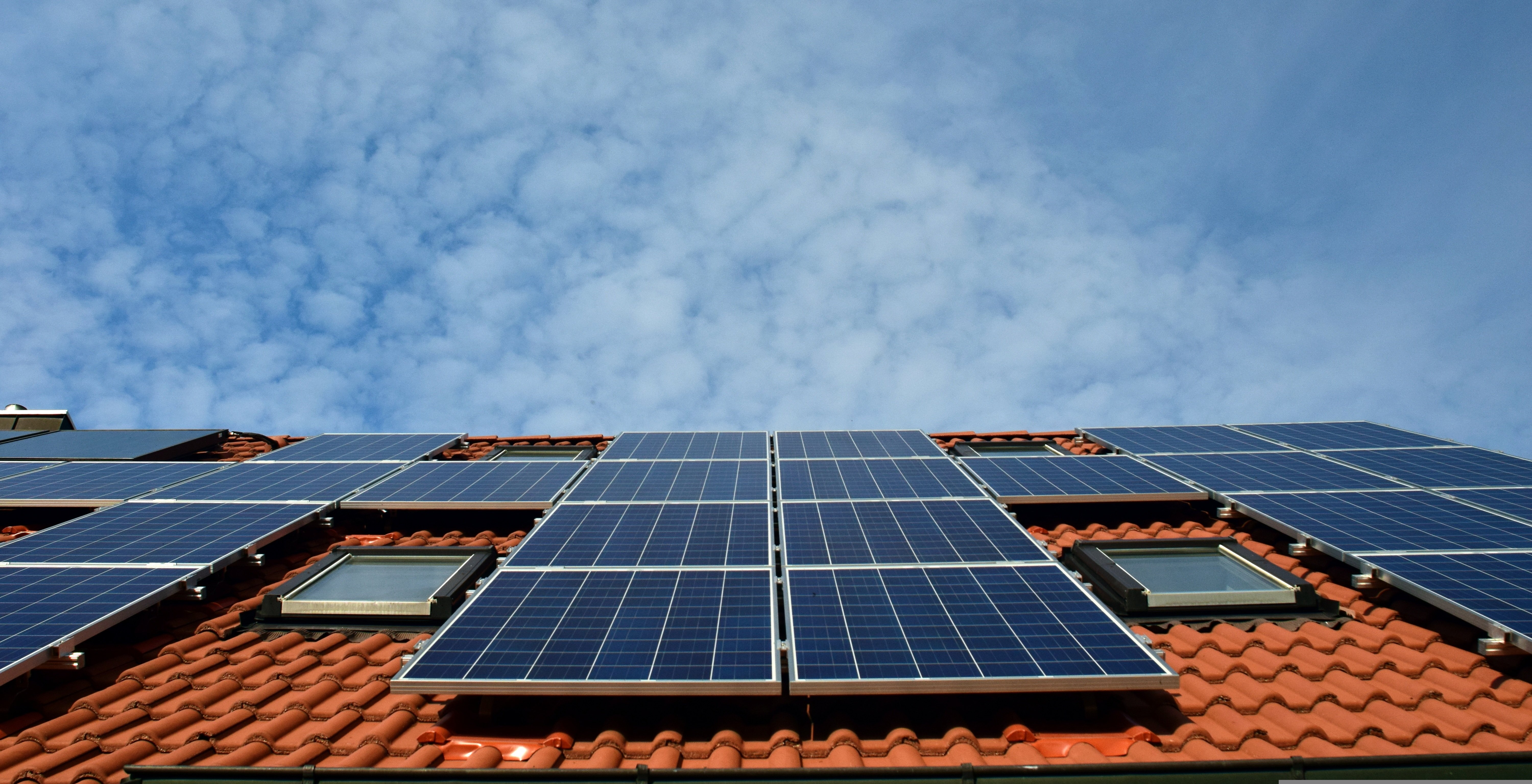 Solar panels under a wide sky